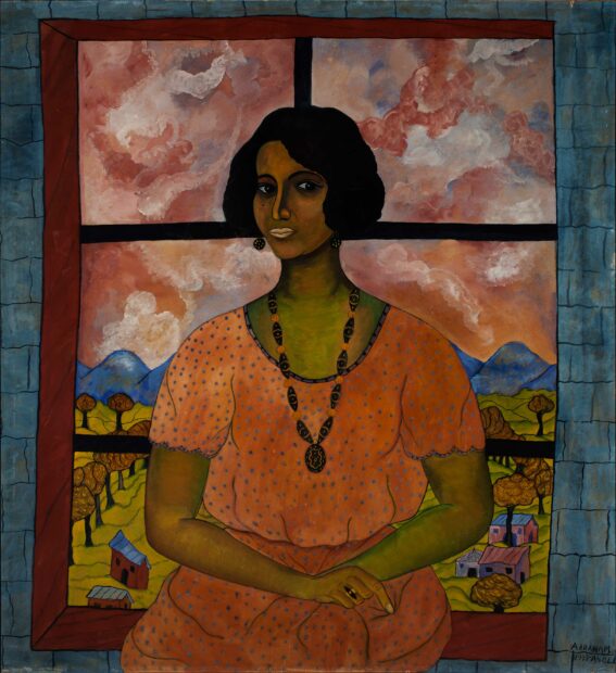 Portrait of a woman seated in front of a window