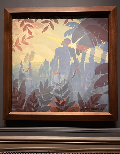 A photograph of a large painting by Aaron Douglas featuring silhouetted figures in chains walking toward distant ships.