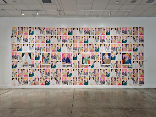 Installation view of seven rows of portrait paintings on paper