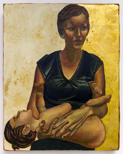 Image of a portrait of a woman holding a baby sitting against a gold backdrop