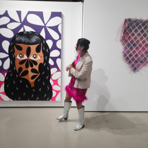 Installation view of a visitor in front of a portrait painting