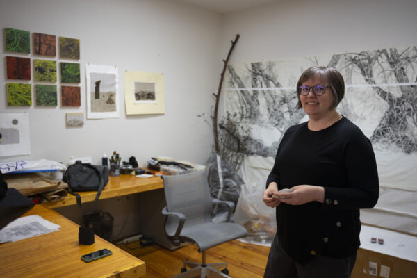 A photograph of artist Hollis Hammonds in her studio.
