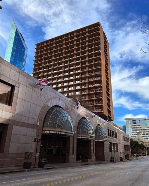A photograph of the exterior of the Fairmont Hotel in downtown Dallas.