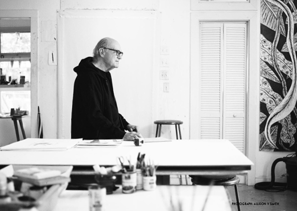 A black and white photograph of artist Frank X. Tolbert 2 in his studio.