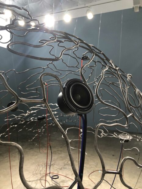 Installation view of an aluminum sphere with speakers embedded