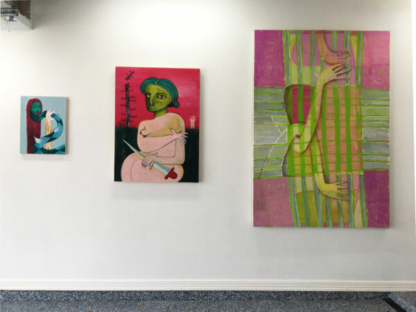 Installation view of three paintings on a wall