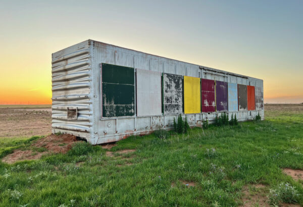 Photo of laarge scale paintings on a shipping container after a year of wear