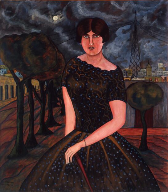 Portrait of a woman sitting in a city nightscape