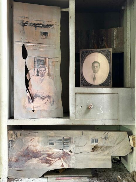 Installation view of portraits in a wardrobe