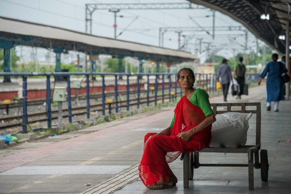 Photo of a woman sitting on a train platform