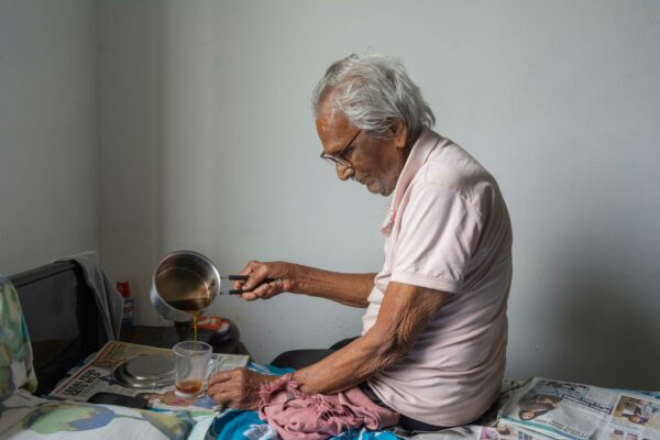Photo of an elderly man making tea