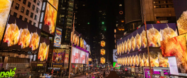A photograph of Times Square with all of the screens showing the same abstracted image from a video by Shahzia Sikander.