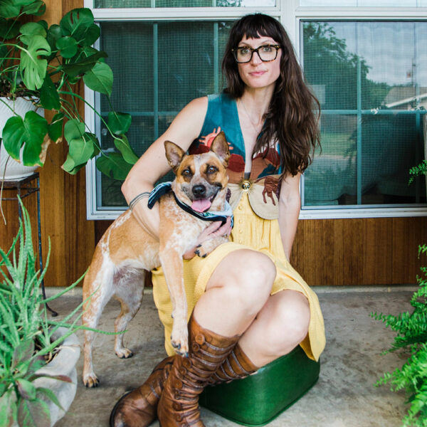 A photograph of artist Suzanne Wyss with her dog.