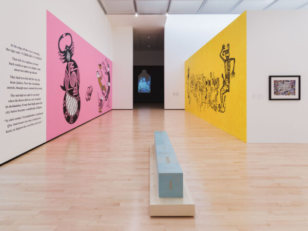 Installation view of two works against a yellow wall and a pink wall