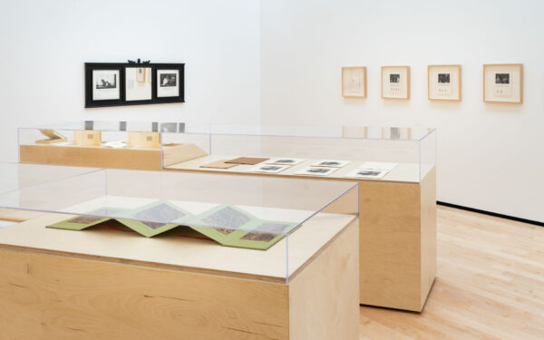 Installation view of vitrines with works on paper laid in them
