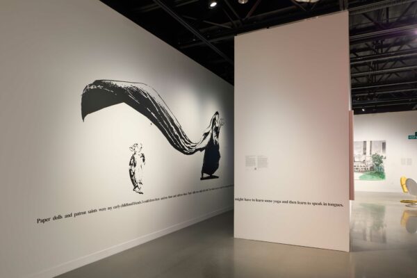 Installation view of vinyl text along a white wall
