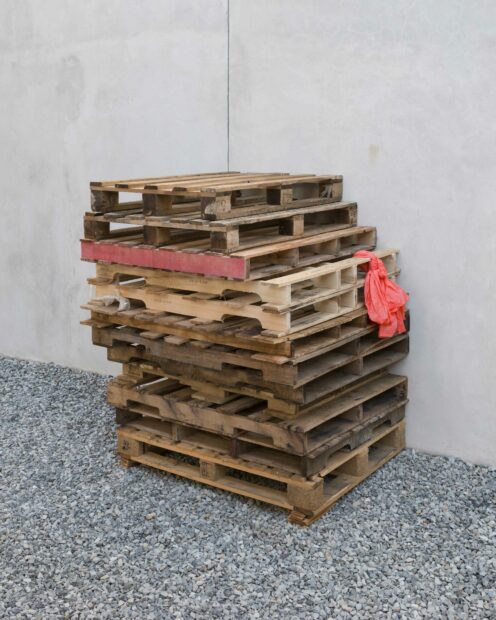 Installation view of wood pallets stacked one on top of another