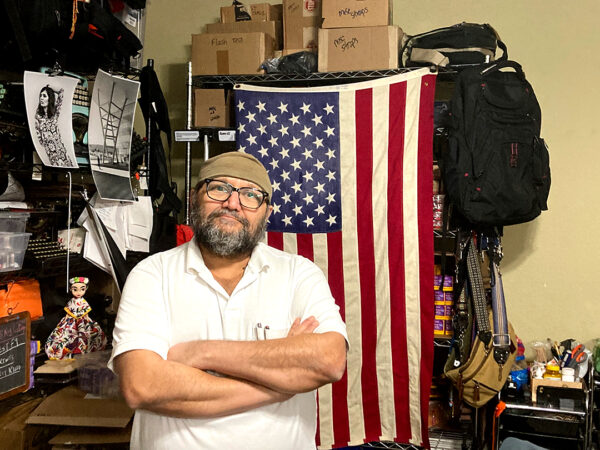 A photograph of Pino Shah in his film shop in McAllen.
