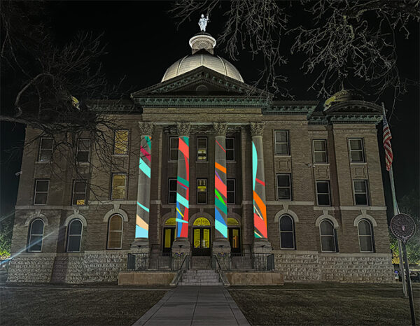 A digital rendering featuring an abstract projection on a building.