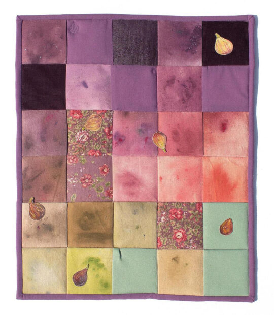 A photograph of a mixed media fabric work by Beronica Gonzales that is reminiscent of a quilt.