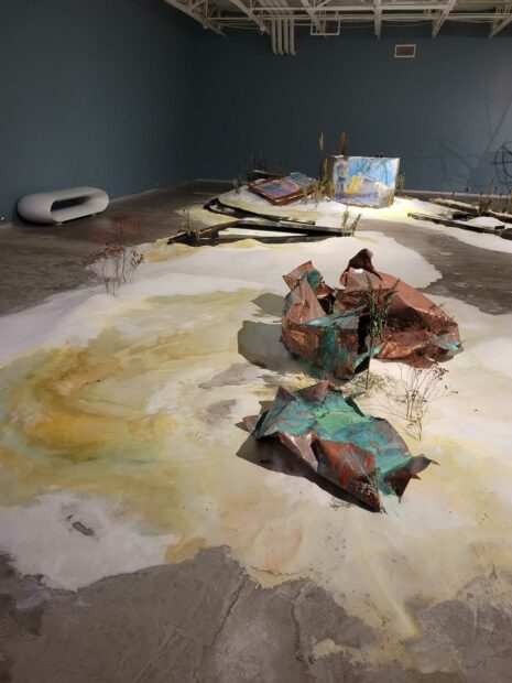 Installation view of soft sculptures and detritus on a gallery floor