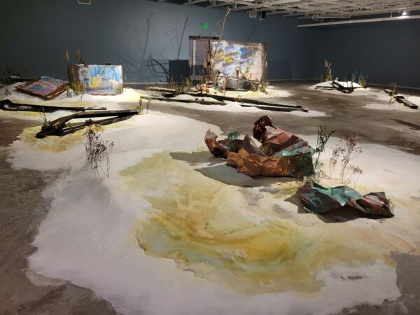 Installation view of soft sculptures and detritus on a gallery floor