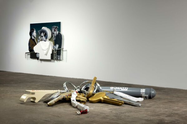 Installation view with a large sculptural set of keys and a wall drawing