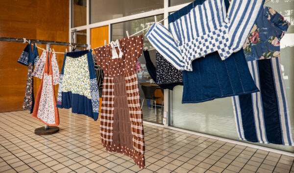 A photograph of an installation of clothes hung on a clothesline.