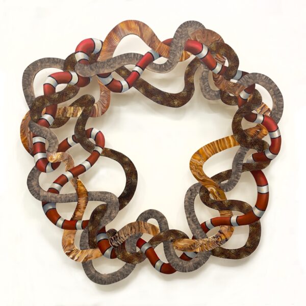 A photograph of a mixed media work on plywood by Gabriela Magana, featuring intertwining snake-like shapes.