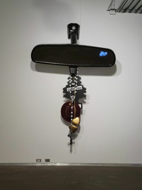 Large sculptural installation piece of a rear view mirror with hanging ornaments