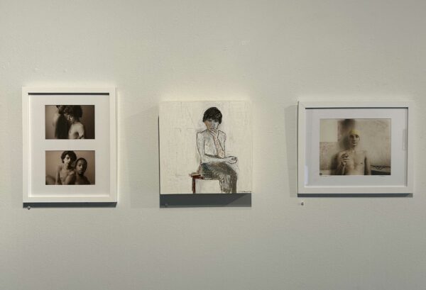 Installation view of three works works of portraiture on a wall