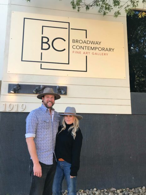 A couple standing in front of the Broadway Contemporary Fine Art Gallery