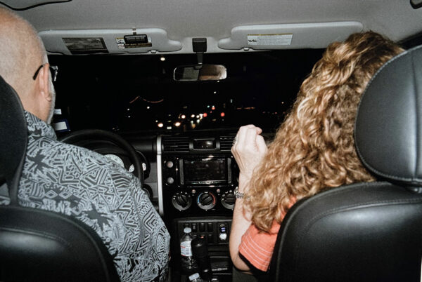 Photo of two people in the front seats of a car