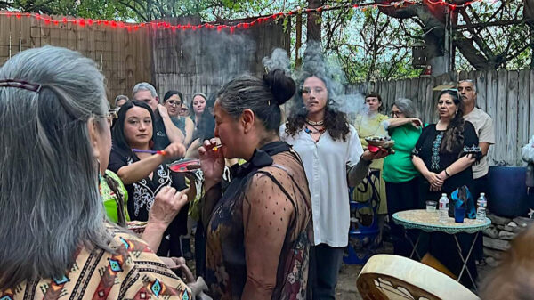 Photo of people partaking in a copal blessing