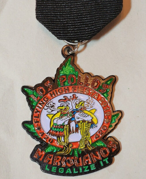 Fiesta medal with two chickens smoking weed