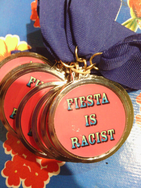 Fiesta medal that says "Fiesta is racist"
