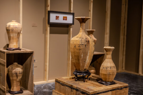 Installation images of cardboard vessels made by art handlers