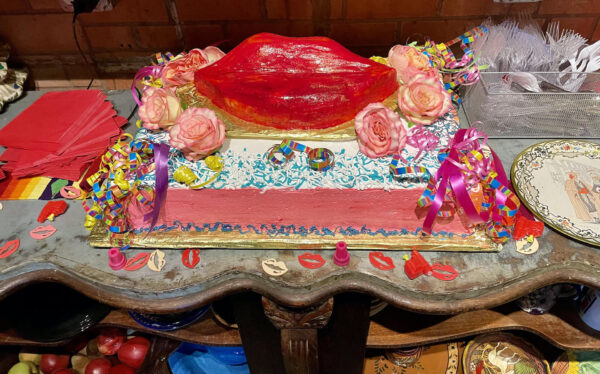 Installation view of aa cake with large red lips