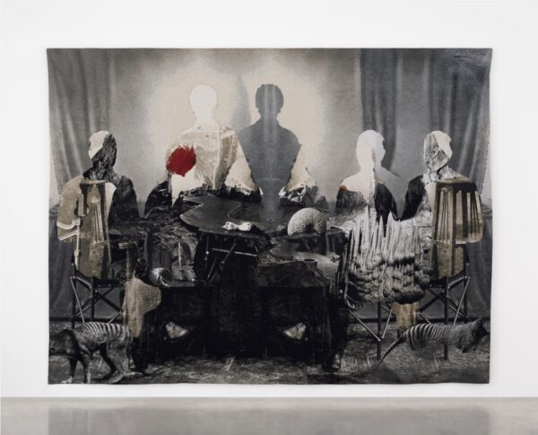 An installation image of a large scale tapestry work by Ailbhe Ní Bhriain, featuring cut out silhouettes of figures.