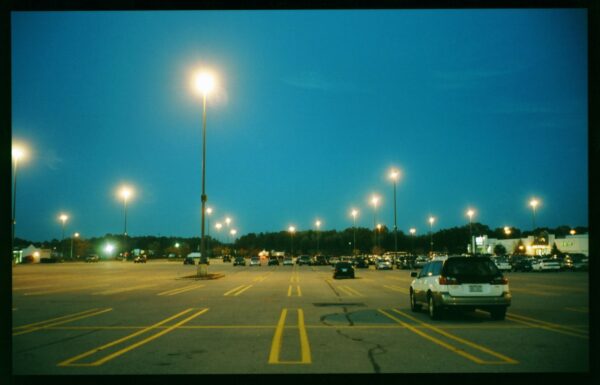 Image of a near-empty parking lot at dusk
