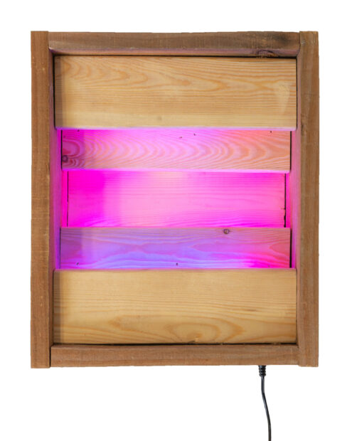 A wooden box featuring an LED light that changes colors.