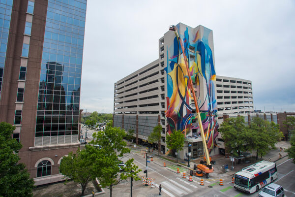 A photograph of a large scale mural in process in Houston.