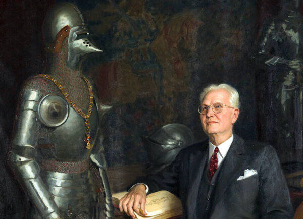 Portrait of a white man next to medieval armor