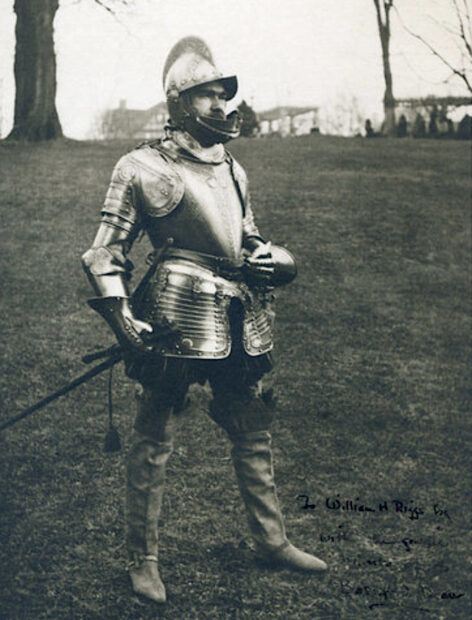 Black and white photo of a man wearing armor in a field