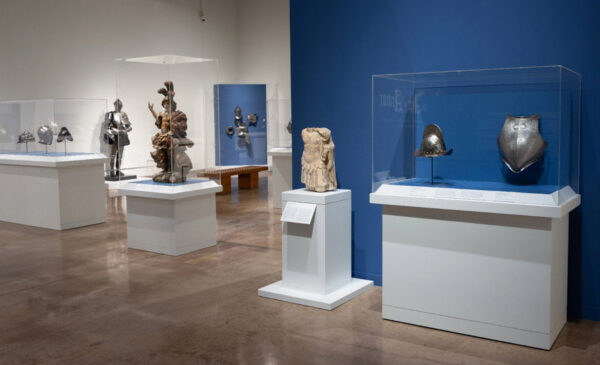 Installation shot of armor in a museum gallery