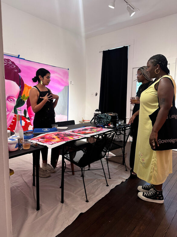 A photograph of curators Christian Reeder and Jordan Barrant talking with artist Kat Cadena.