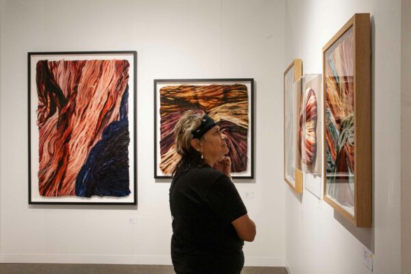 Photo of a visitor looking at works on a wall at the Affordable Art Fair