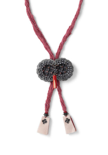 Detail of a reddish pink bolo tie