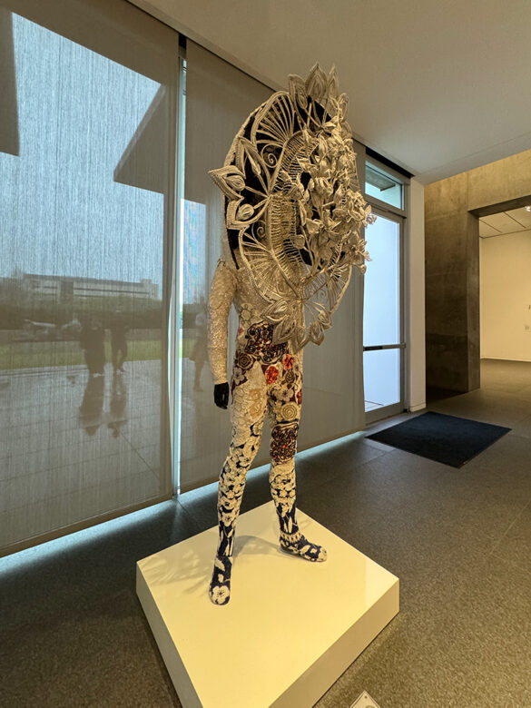 An installation image of an elaborate soundsuit by Nick Cave.