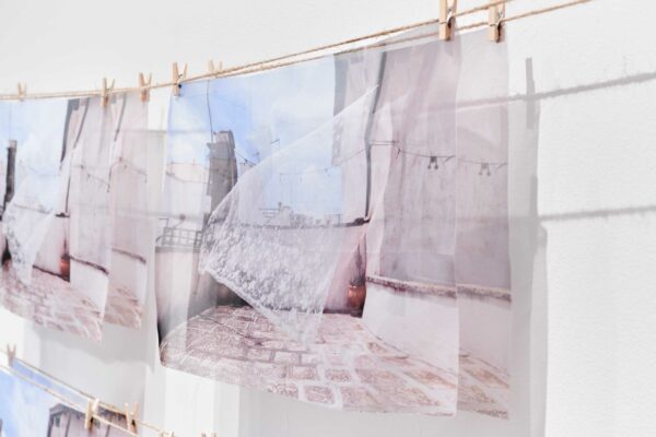 Translucent Prints hang from clothespins on the wall of a gallery.5. Sarah Sudhoff, “Embodied Presence,” 2024, photographic prints on feather voile
